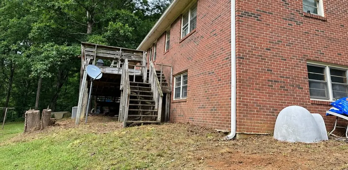 After: the back of the house cleared, brush and debris hauled away